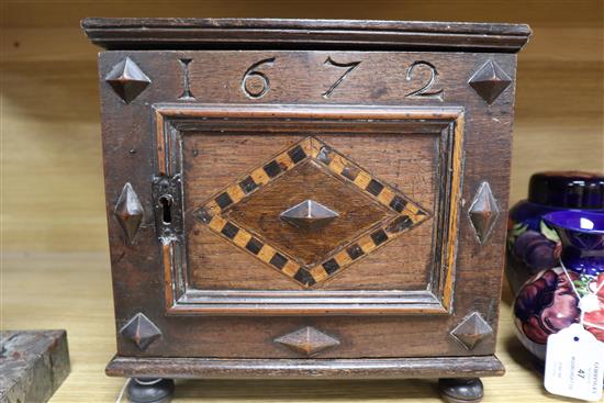 An inlaid oak spice cabinet, carved with the date, 1672 W.29cm